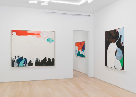 installation view of multiple paintings in a white room