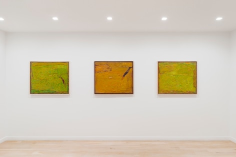 installation view of paintings in a white room