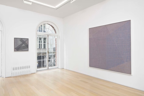 installation view of paintings in a white room