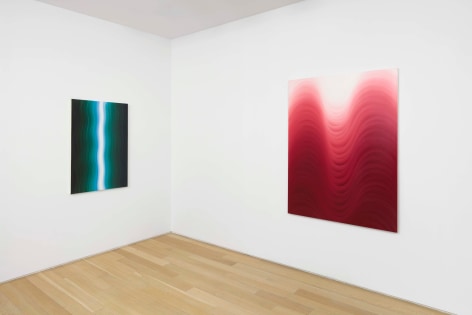 installation view of paintings in a white room