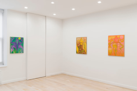 installation view of paintings in a white room