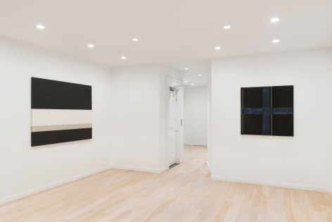 installation view of paintings in a white room