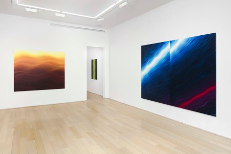 installation view of paintings in a white room