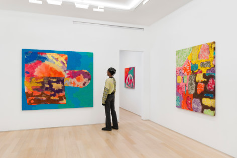 installation view of paintings in a white room