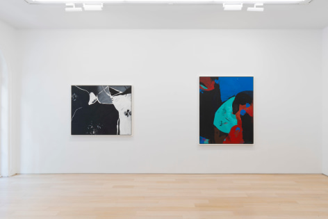 installation view of multiple paintings in a white room