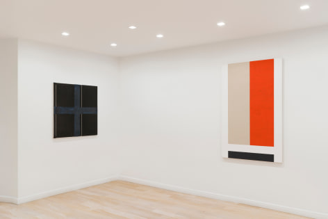 installation view of paintings in a white room