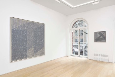 installation view of paintings in a white room