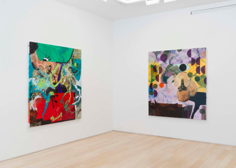 installation view of paintings in a white room