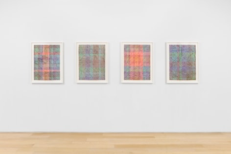 installation view of paintings in a white room