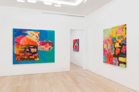 installation view of paintings in a white room