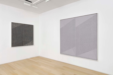 installation view of paintings in a white room