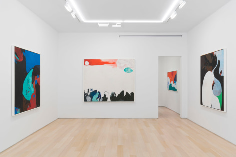 installation view of multiple paintings in a white room