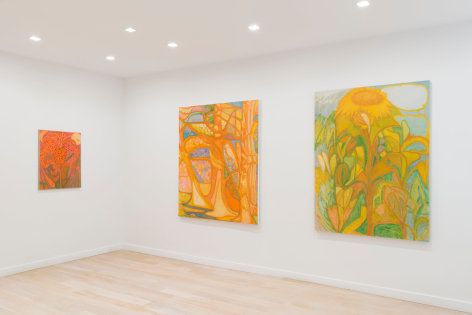 installation view of paintings in a white room