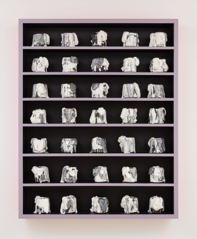 cabinet with a bunch of little ceramic pots in it