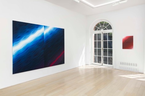 installation view of paintings in a white room