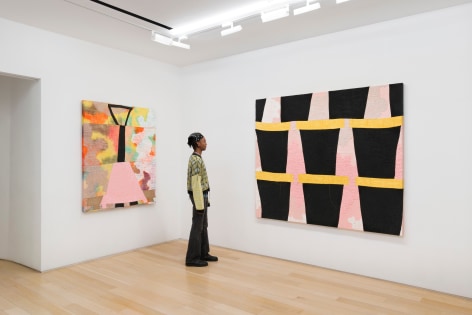 installation view of paintings in a white room