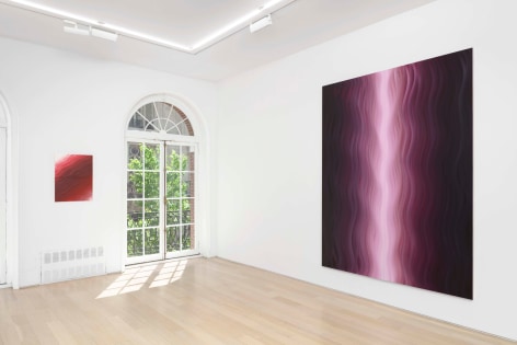 installation view of paintings in a white room