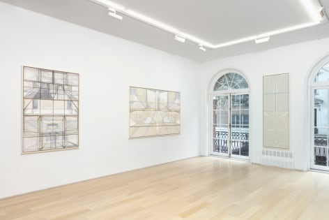 white gallery space with art on walls