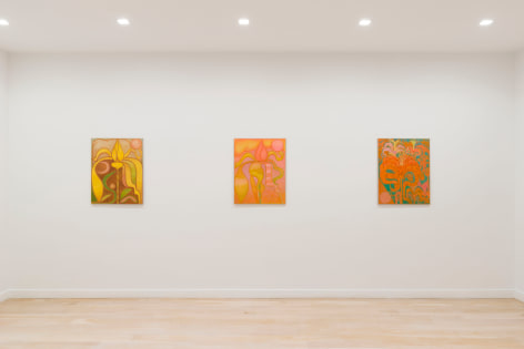 installation view of paintings in a white room