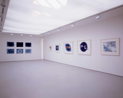 installation view with about 10 framed drawings in a large gallery