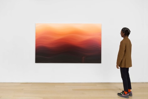 installation view of paintings in a white room