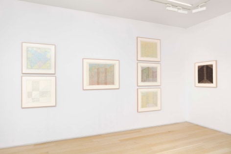 installation view of paintings in a white room