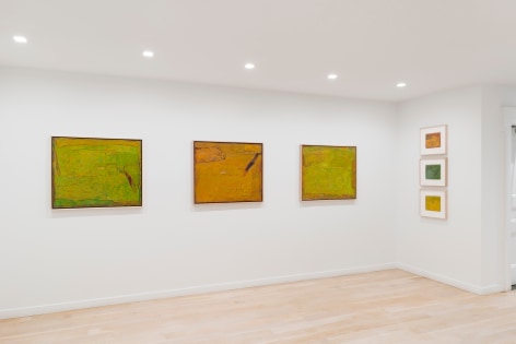 installation view of paintings in a white room