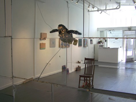 Gallery view of artist installed mirror, with light up penguin