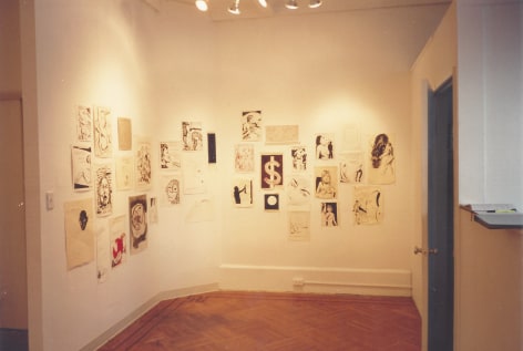 Drawings on paper hung on gallery walls