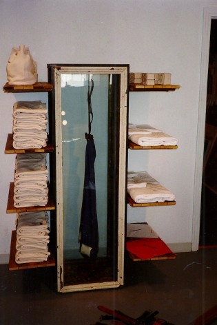 Clothing shelved, with piece dangling inside box