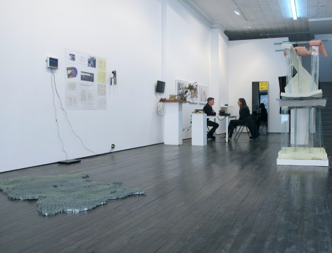 Gallery view of multi media works, and couple sitting