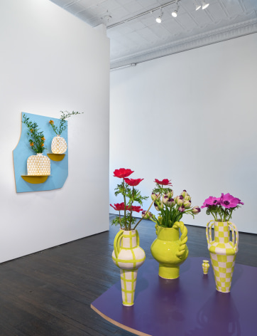 Installation view of painted ceramic cases