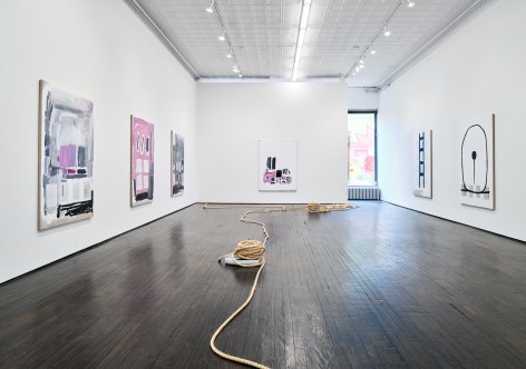 Gallery view showing abstract paintings and rope sculpture