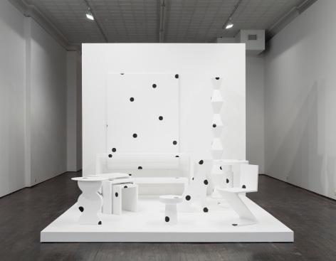 Abstract white furniture covered in black polka dots