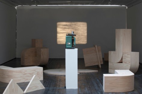 Gallery view of projection and wooden sculptures