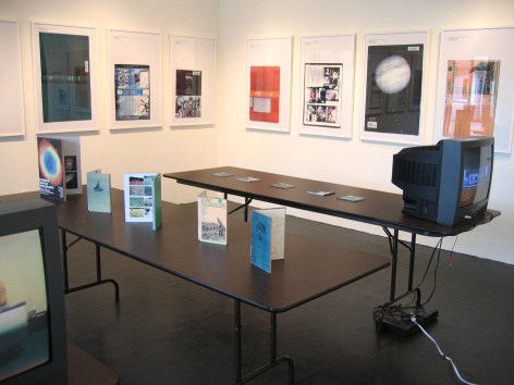 Installation view of framed book spines and books displayed