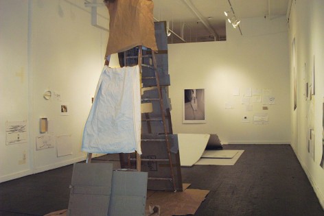installation view of ladder covered in cardboard