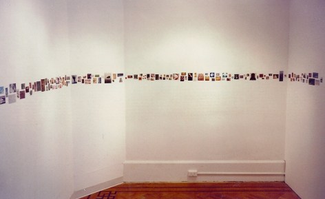 Installation view of postcard sized images on gallery walls