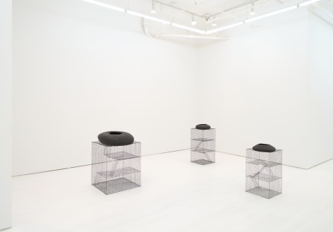 Black vases on wireframe columns, gallery view