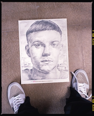 Photo of person looking down on portrait sketch