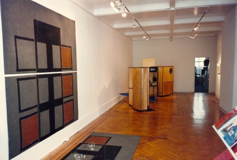 Installation view showing painted carpet, as well as foldable kitchens