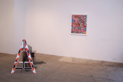 Gallery view of framed artwork and police barrier