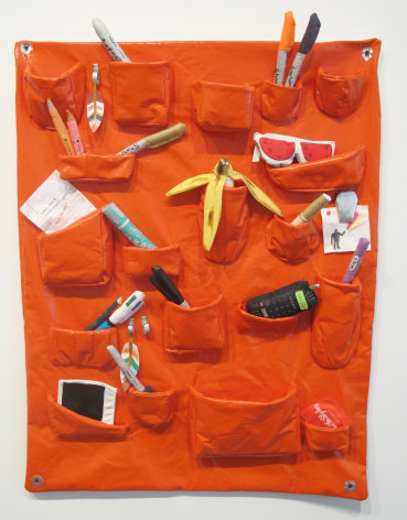 Individual view of Whitmarsh piece, featuring items in orange pockets