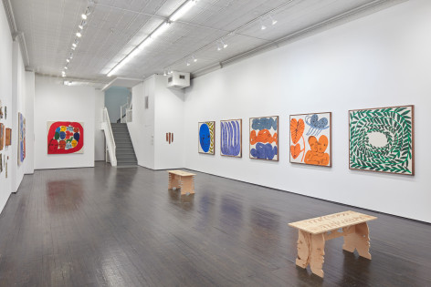 Gallery installation view of multiple Emma Kohlmann paintings and wooden benches