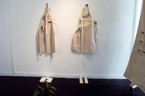 Aprons hung on gallery walls