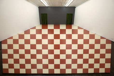 Red and white checkered optical illusion on gallery floor