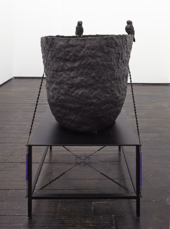 Black ceramic sculpture of bird nest