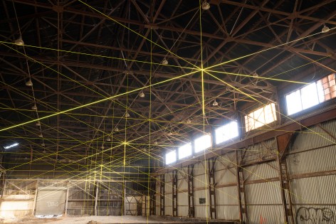17,000 ft2 of Shade (2018-2019) Neon-yellow rope, hardware, sunlight 205 x 84 x 60 feet