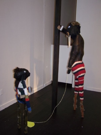 Two rat-like figures, standing in gallery
