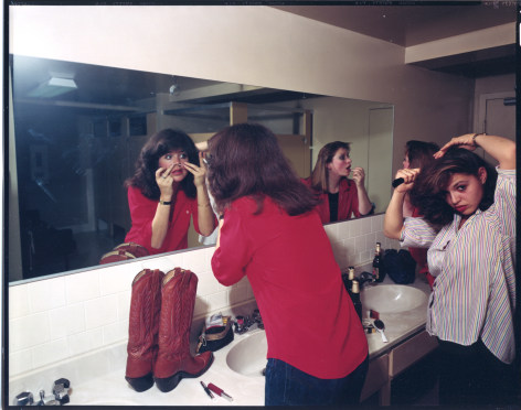 Women applying makeup in the mirror